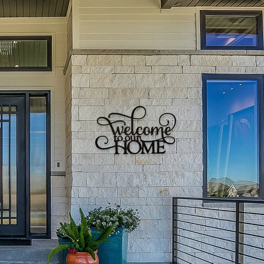 A metal welcome sign that is hanging on the front porch.