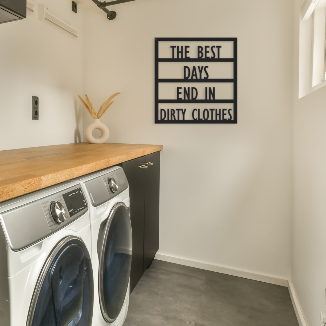 Modern laundry room metal sign that is hanging by the washer and dryer.