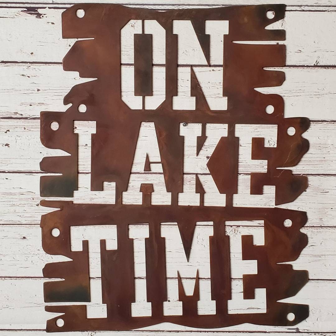 Lake house decor that is a metal sign that says On Lake Time.