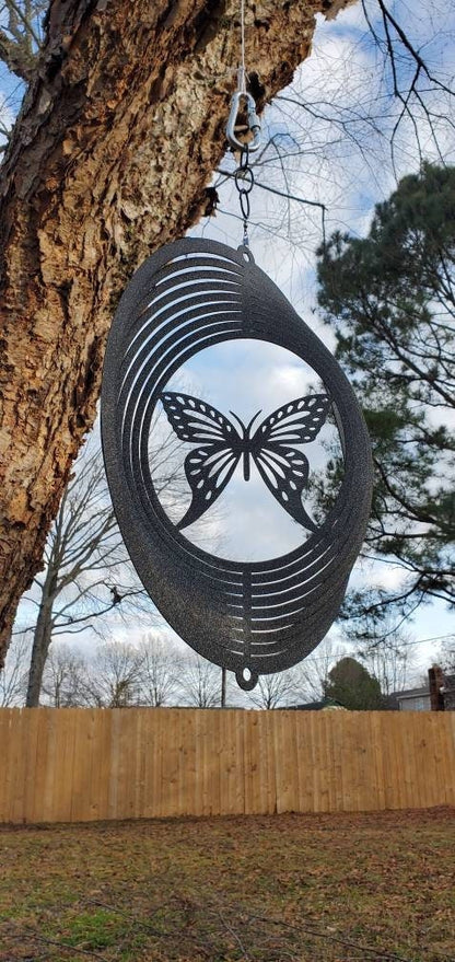 Butterfly Metal Wind Spinner hanging from a tree.