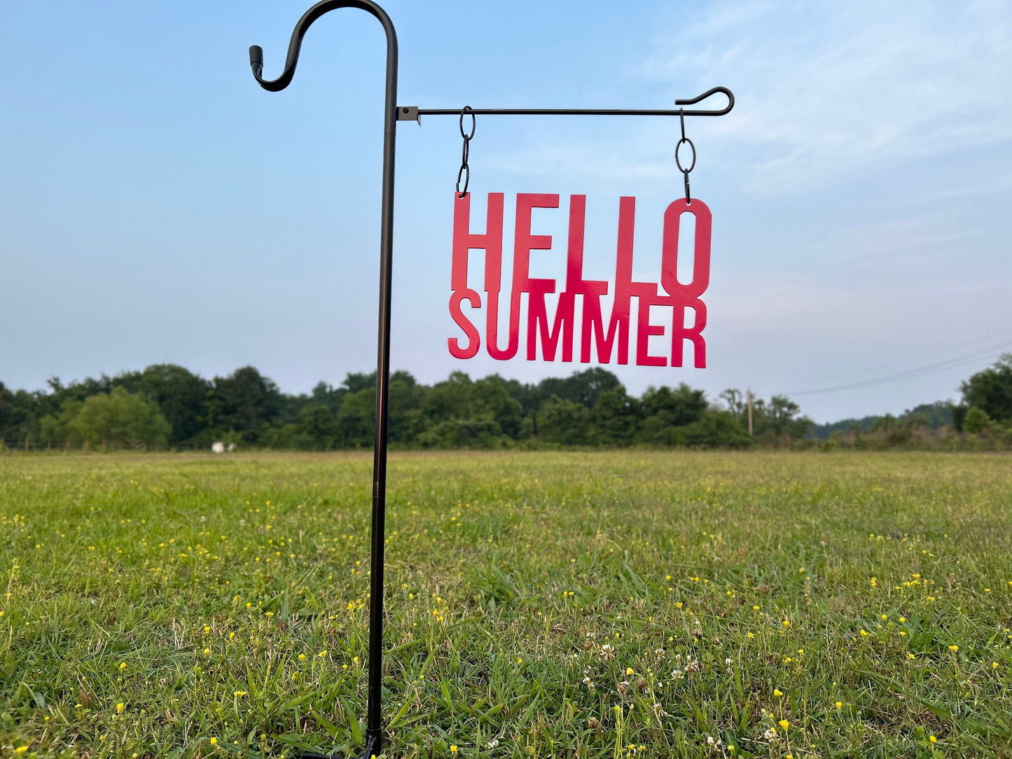 A summer garden flag that says Hello Summer. It is made out of metal.