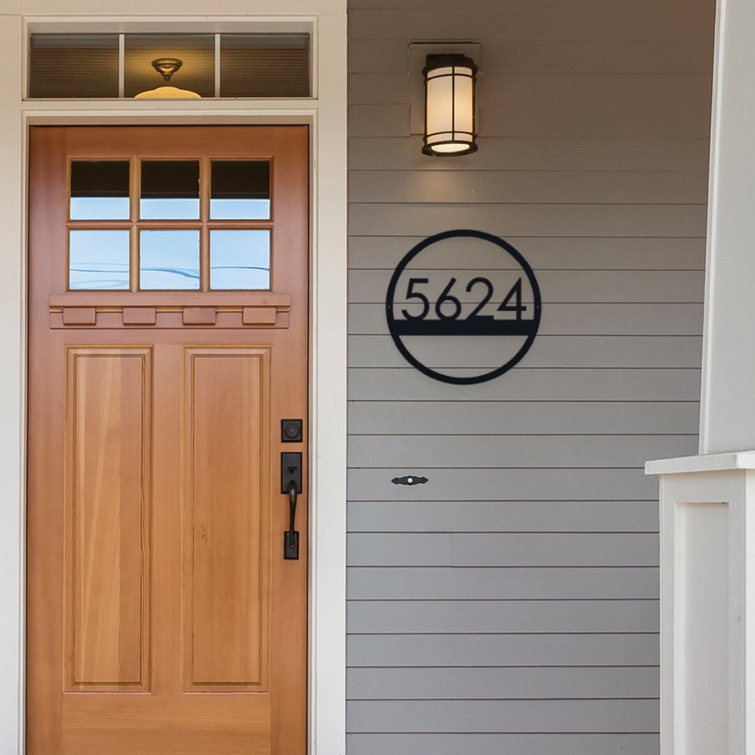 Modern Round Metal Address sign that is hanging on the front porch.