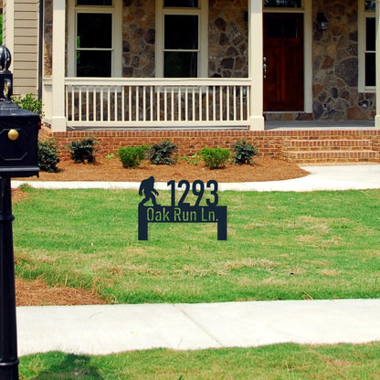 Metal address lawn sign that has a bigfoot on the top left.