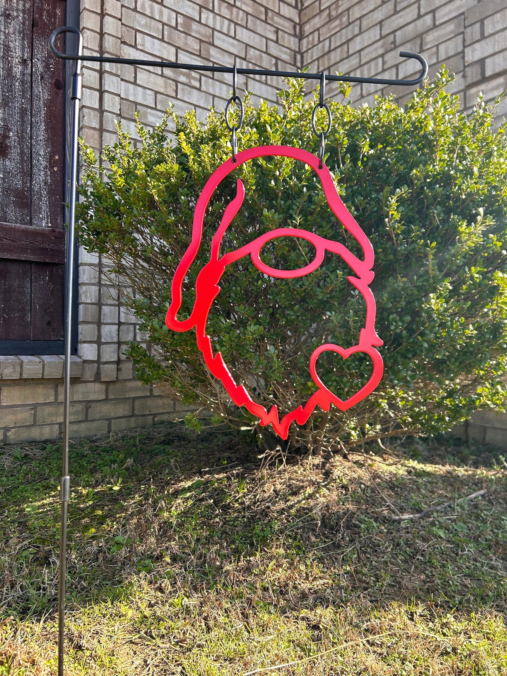 Gnome metal garden flag that has a heart on his beard.